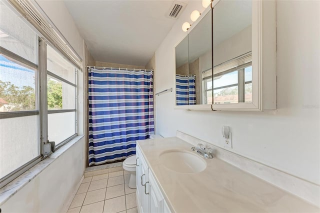 bathroom with vanity, toilet, curtained shower, and tile patterned flooring