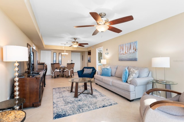 tiled living room with ceiling fan