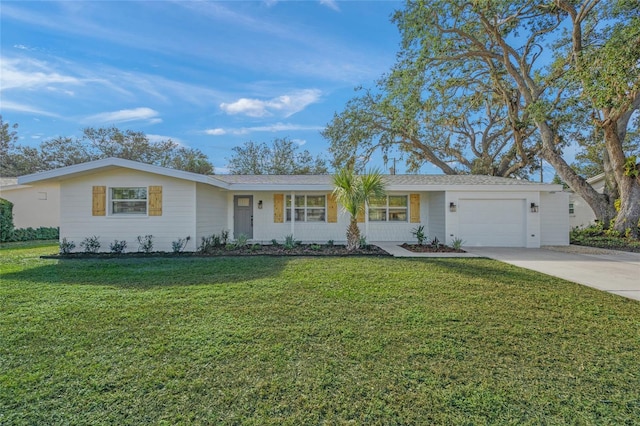 single story home featuring a garage and a front lawn