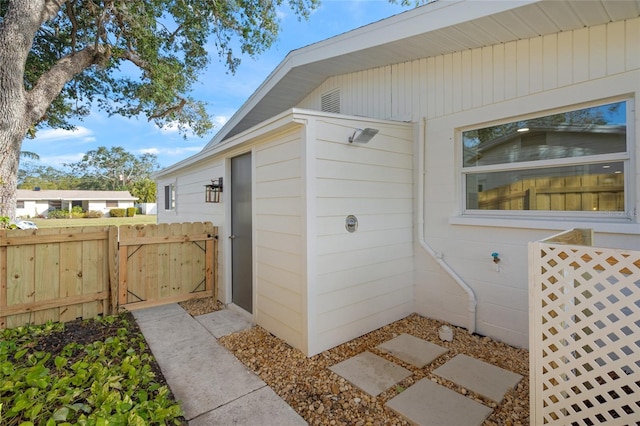 view of side of property with a gate and fence