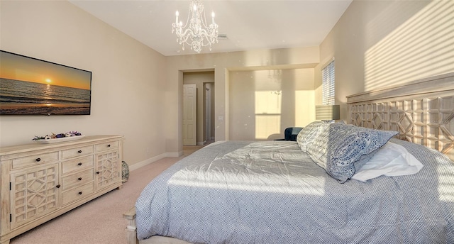 carpeted bedroom featuring a notable chandelier