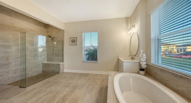 bathroom featuring independent shower and bath and vanity