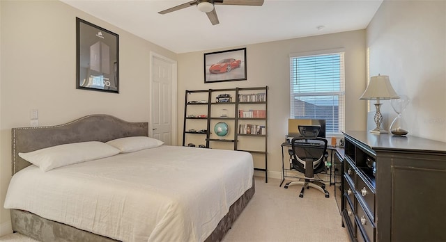 bedroom with ceiling fan and light colored carpet