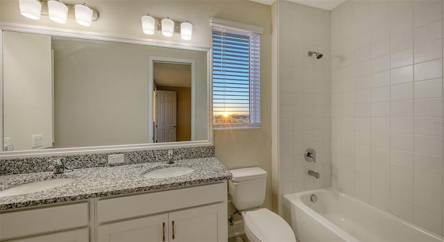 full bathroom with vanity, tiled shower / bath, and toilet