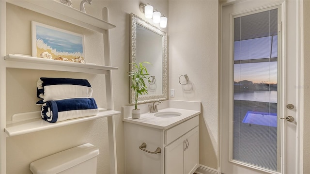 bathroom featuring vanity and toilet