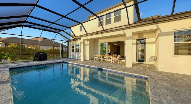 view of swimming pool with a patio, a lanai, and area for grilling