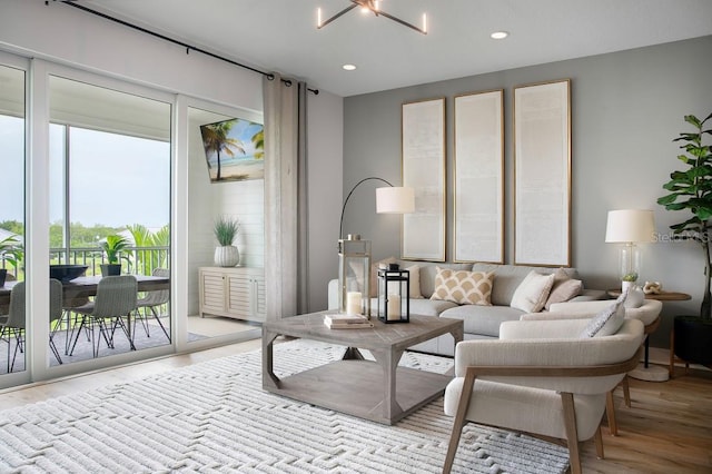 living room with a chandelier and light hardwood / wood-style flooring