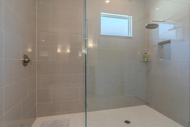 bathroom with tiled shower