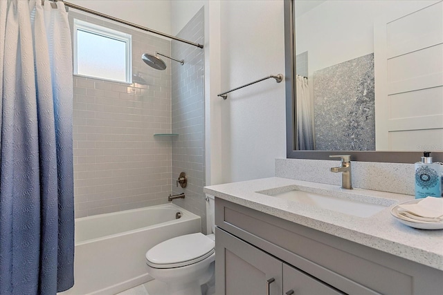 full bathroom featuring vanity, shower / bath combo, and toilet