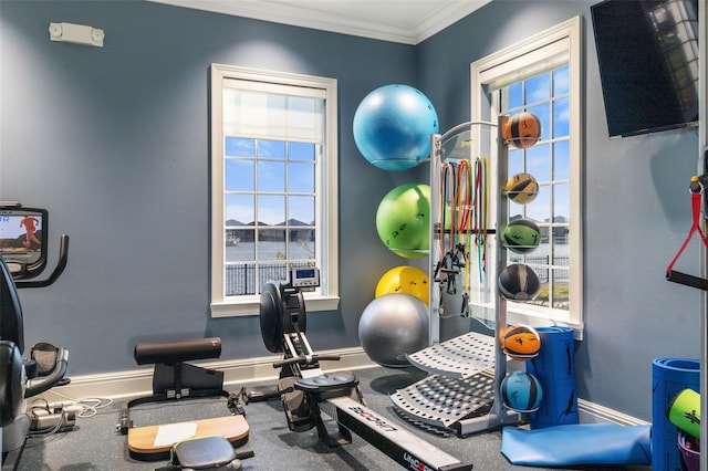 workout area featuring crown molding