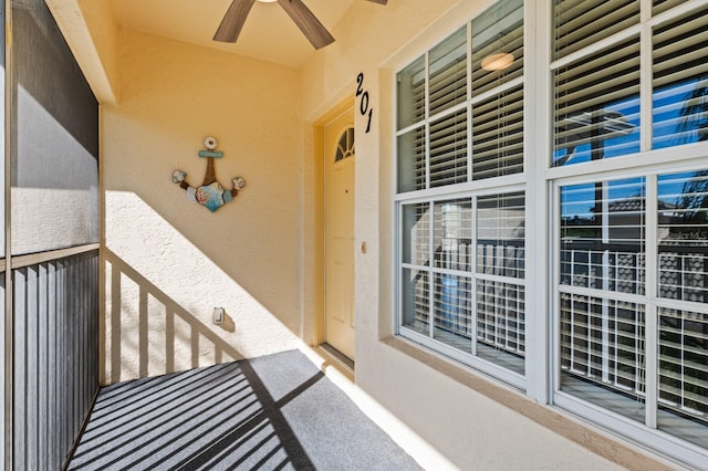 doorway to property with ceiling fan