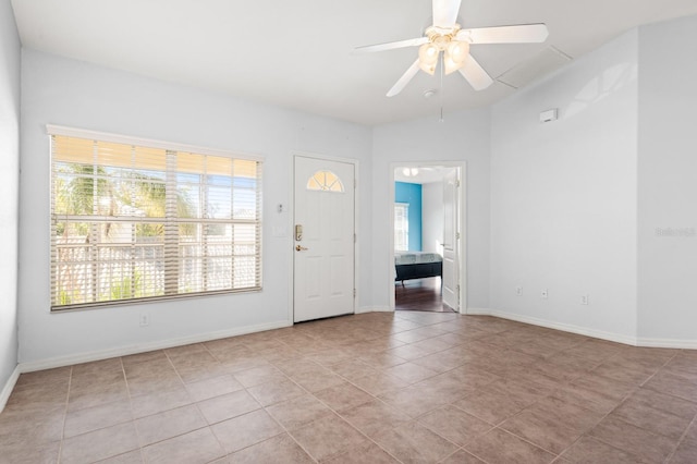 tiled foyer entrance featuring a healthy amount of sunlight and ceiling fan