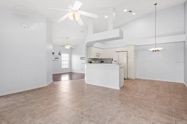 interior space with ceiling fan with notable chandelier, high vaulted ceiling, and light tile patterned floors