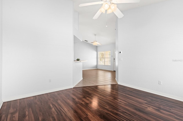 unfurnished room featuring dark wood-type flooring, high vaulted ceiling, and ceiling fan