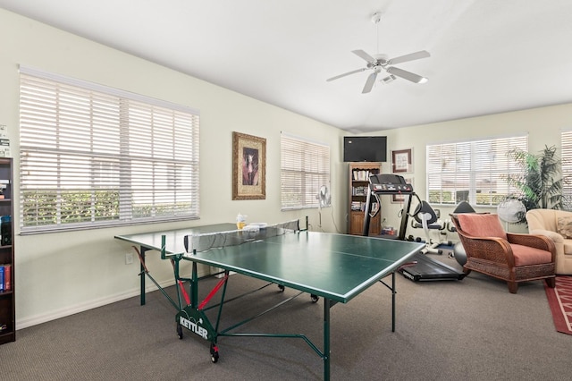 recreation room with vaulted ceiling, ceiling fan, and carpet