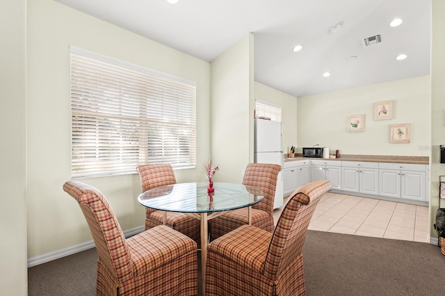 dining space featuring light colored carpet