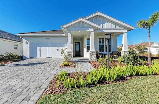 craftsman inspired home with a garage and a porch