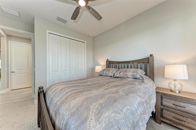 carpeted bedroom with ceiling fan and a closet