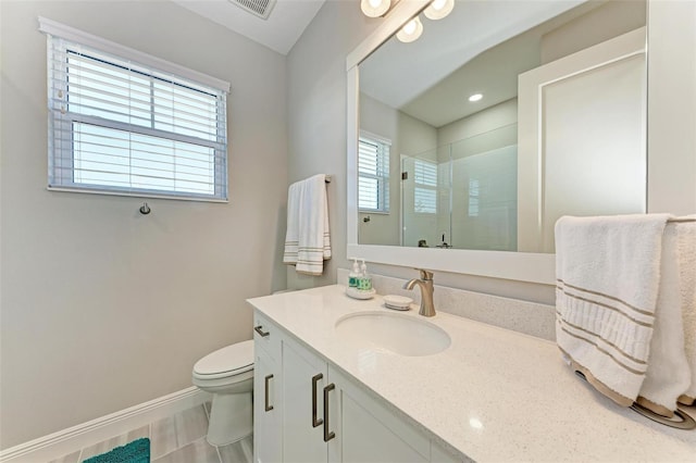 bathroom featuring an enclosed shower, vanity, and toilet