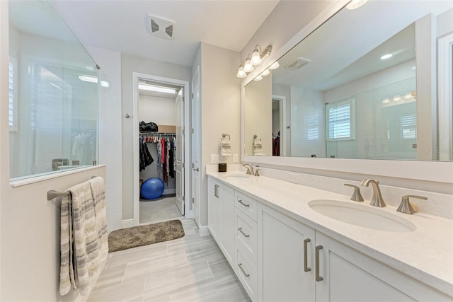 bathroom with vanity and a shower