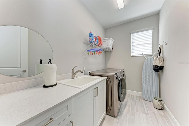 laundry area with cabinets, sink, and washer and dryer