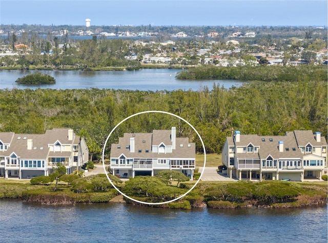 birds eye view of property with a water view