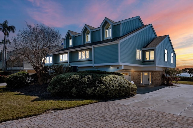 cape cod home featuring a yard