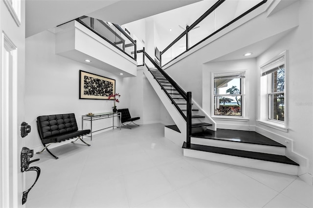 staircase with a towering ceiling