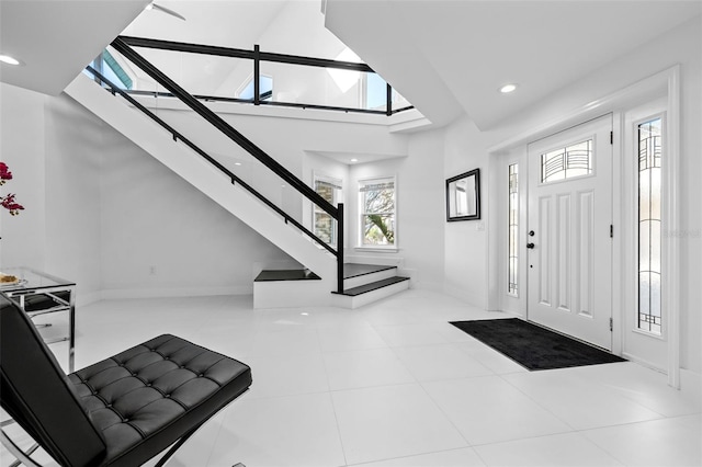 tiled entrance foyer featuring a high ceiling