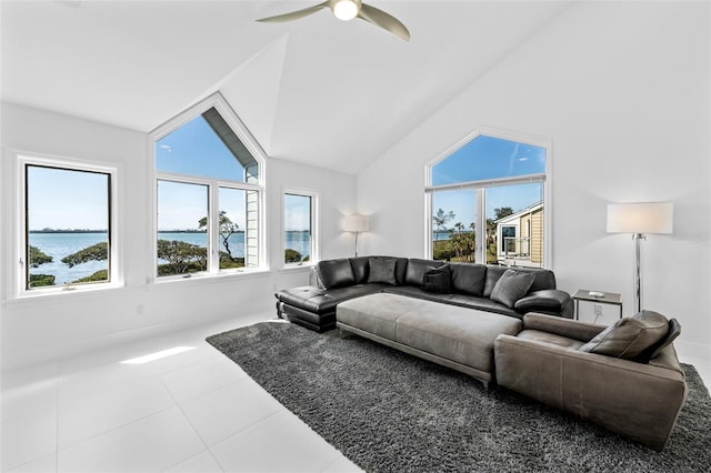 tiled living room featuring a water view, ceiling fan, lofted ceiling, and a wealth of natural light