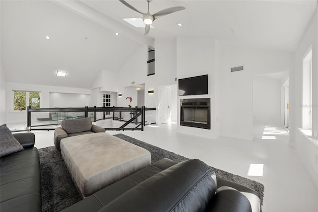 living room with ceiling fan, beam ceiling, and high vaulted ceiling