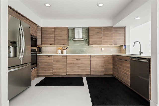 kitchen featuring sink, wall chimney range hood, decorative backsplash, and black appliances