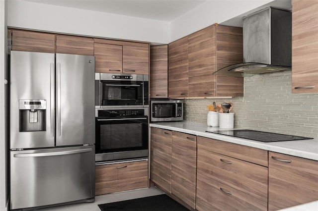 kitchen featuring stainless steel appliances, decorative backsplash, and wall chimney range hood