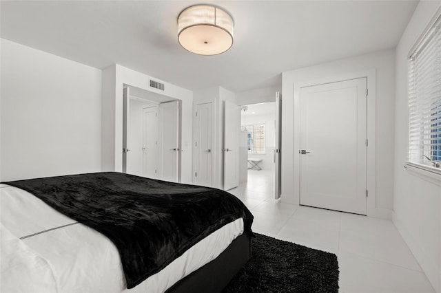 bedroom with light tile patterned floors