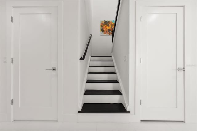 stairs featuring tile patterned floors