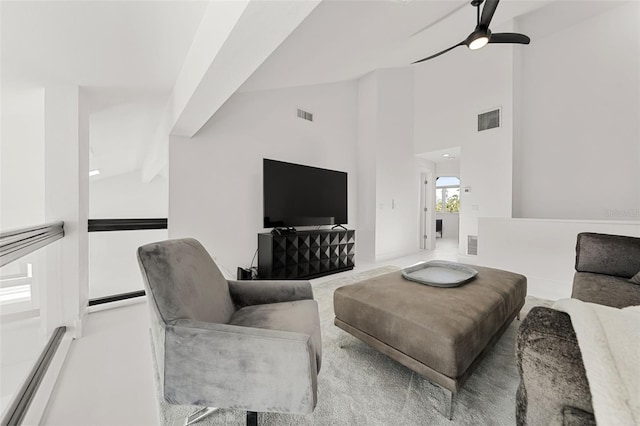 living room with beamed ceiling, ceiling fan, and high vaulted ceiling