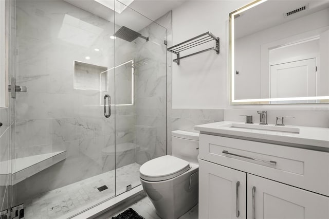 bathroom with vanity, a shower with shower door, tile walls, and toilet