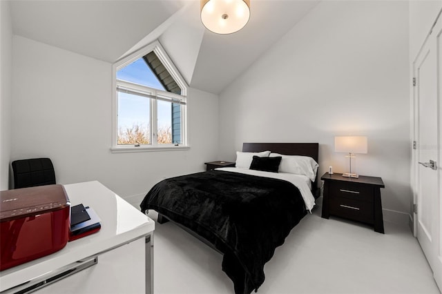 carpeted bedroom featuring lofted ceiling