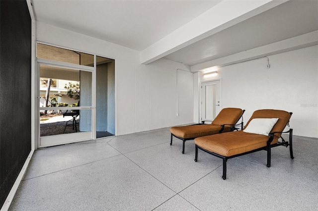 sitting room featuring beamed ceiling