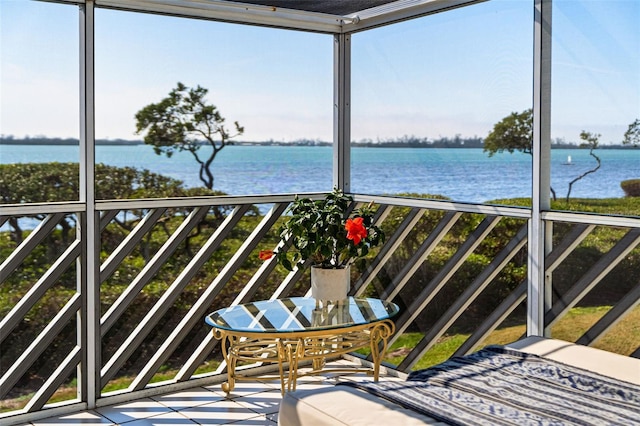 unfurnished sunroom with a water view