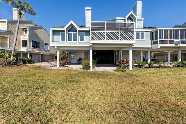 back of house featuring a lawn