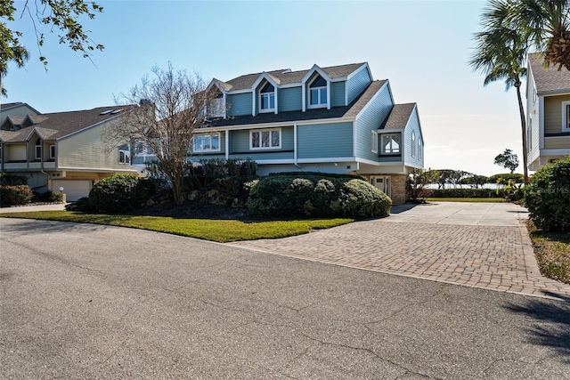 view of front of house with a garage and a front lawn