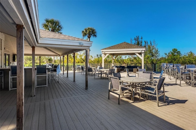 wooden deck featuring a gazebo and exterior bar