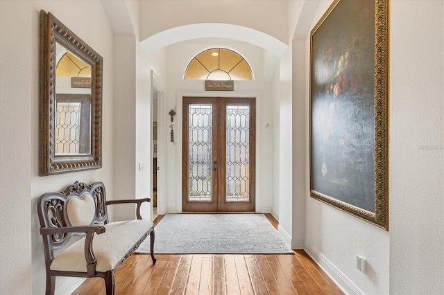 foyer entrance featuring wood-type flooring and french doors