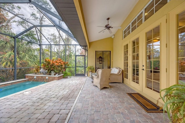 view of patio with ceiling fan, pool water feature, glass enclosure, and french doors