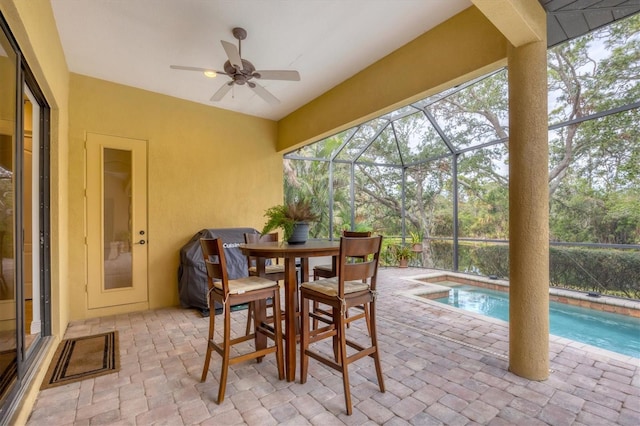 sunroom featuring ceiling fan