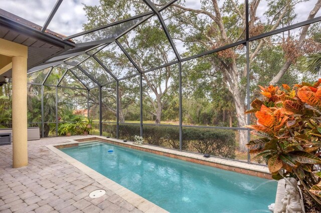 view of pool with a lanai and a patio