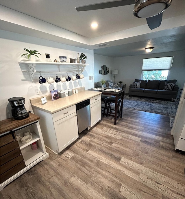 kitchen with white cabinetry, wood-type flooring, and dishwasher