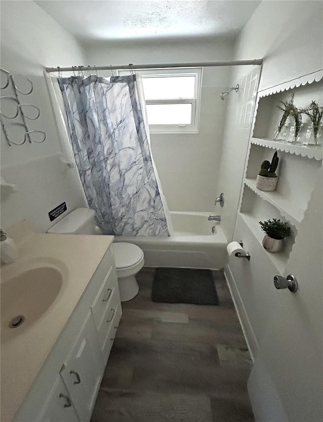 full bathroom with shower / tub combo, hardwood / wood-style floors, vanity, and toilet