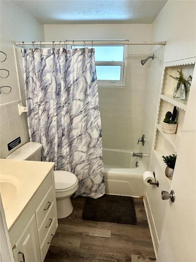 full bathroom with shower / bathtub combination with curtain, vanity, hardwood / wood-style flooring, and toilet